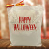 Happy Halloween in red printed on a canvas tote bag sitting on a table