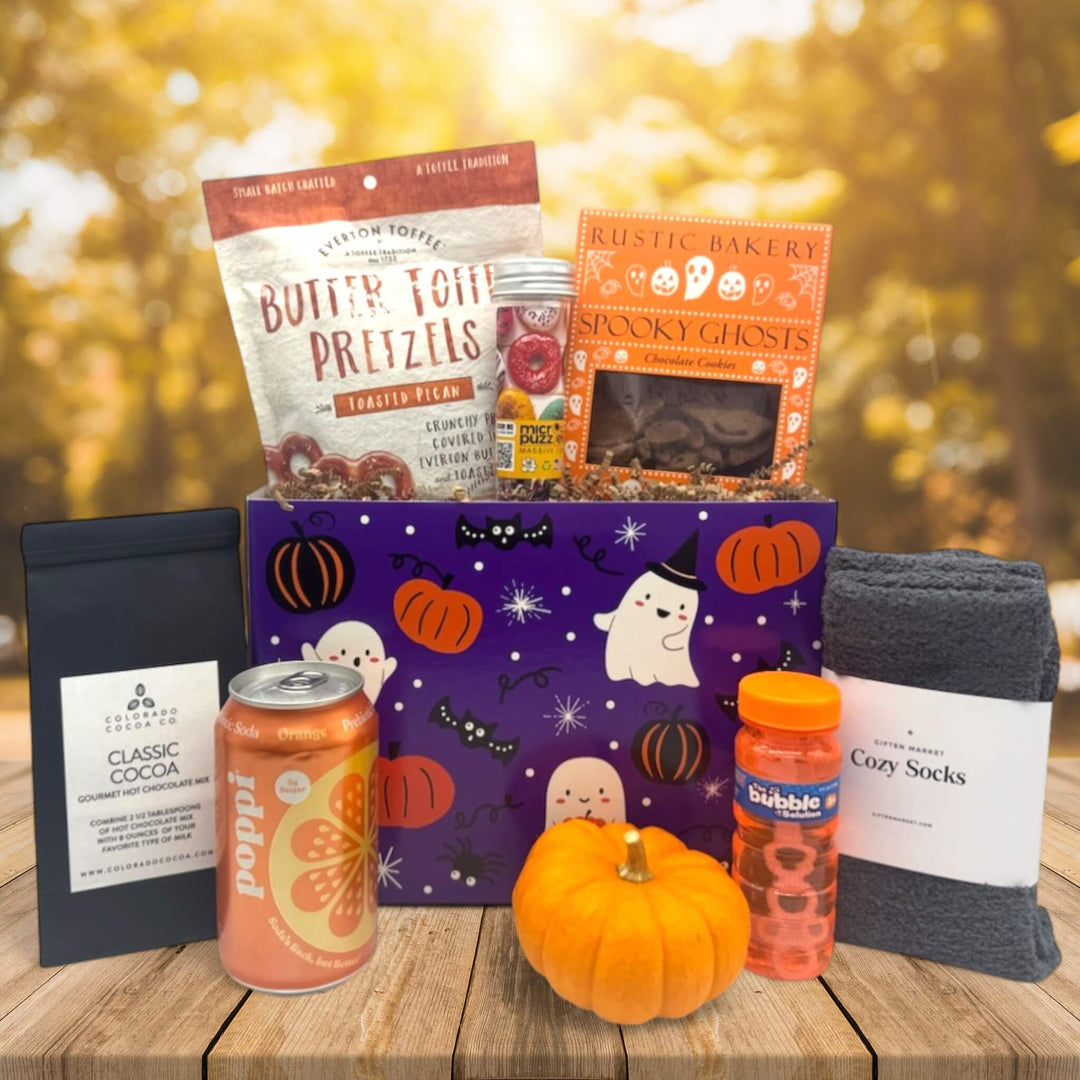 halloween gift box with pretzels, cookies, a puzzle, cocoa, poppi, knit pumpkin, bubbles and socks