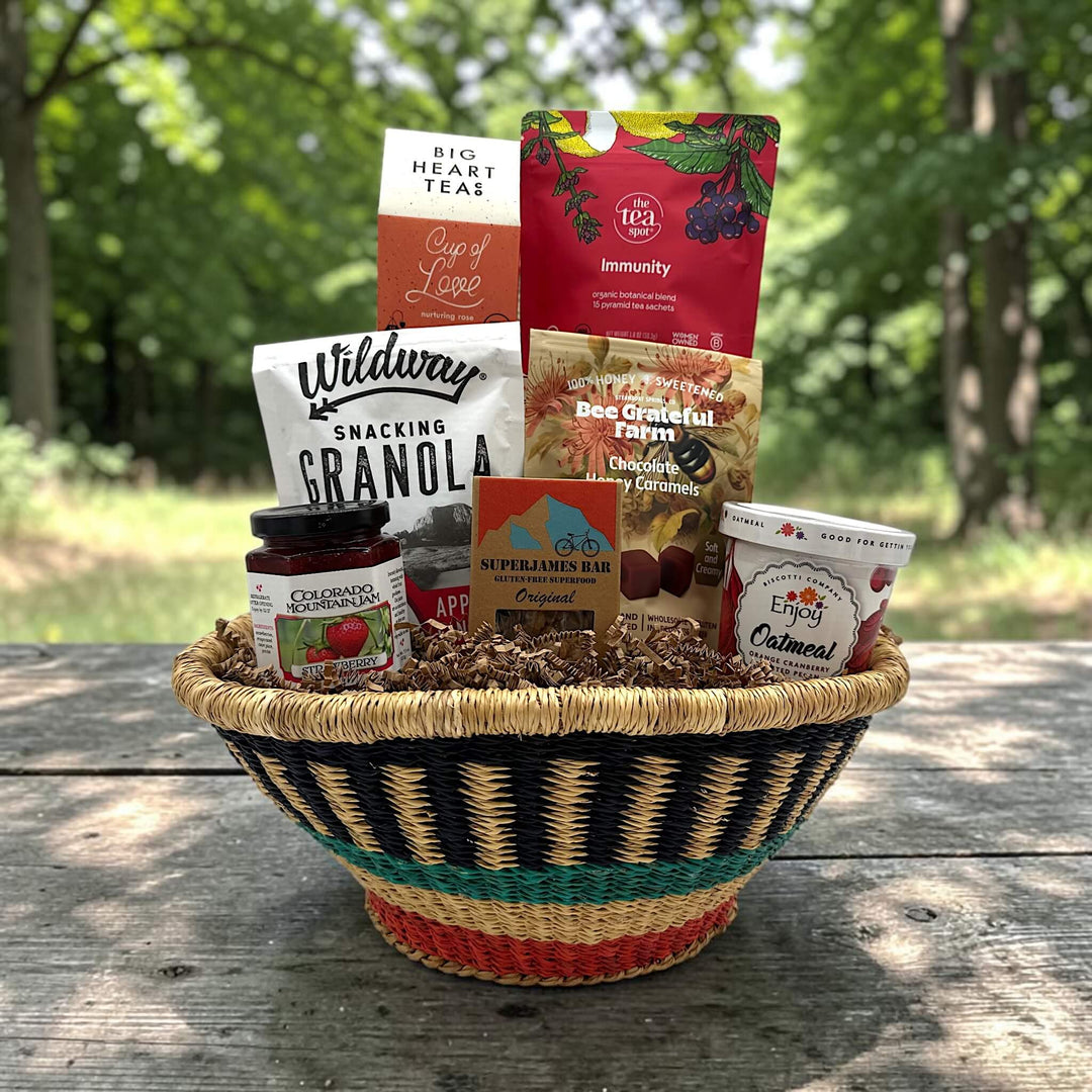handwoven basket with tea, granola, caramels, jam, bar, and oatmeal