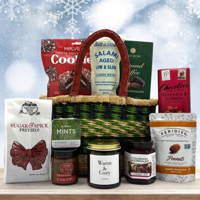 Gourmet holiday handwoven basket with cookies, salami, almond toffee, pretzels with caramel, mints, a large candle, jam, peanuts and a chocolate bar