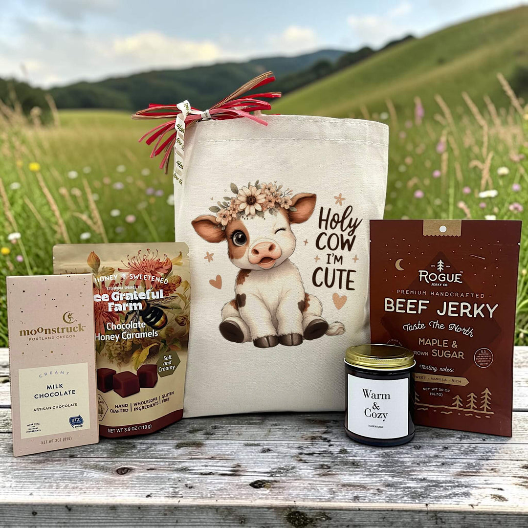 Gourmet new baby gift basket with a chocolate bar, caramels, a large candle and jerky