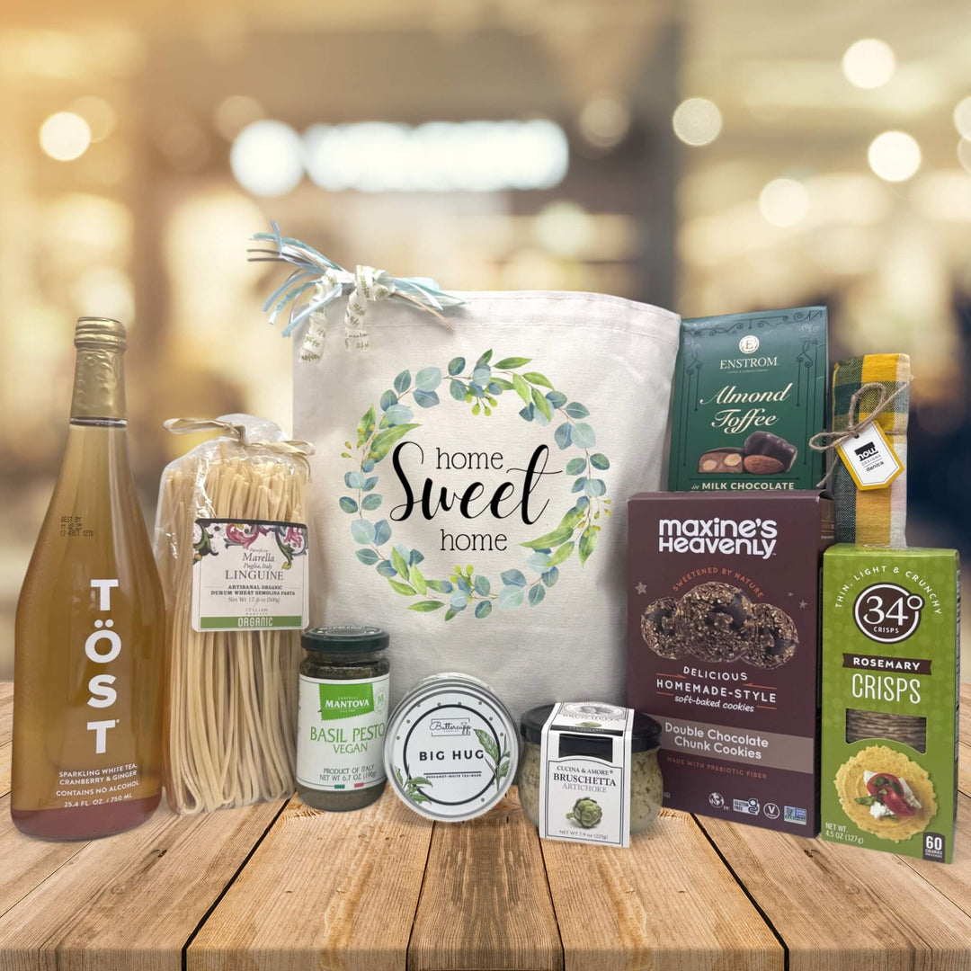 home sweet home floral design on tote bag with sparking juice, pasta, pesto, candle, bruschetta, cookies, dishtowel, and crackers
