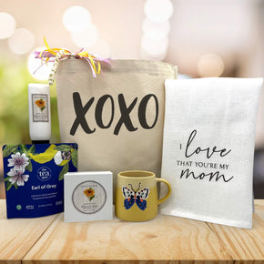 XOXO in black printed on canvas tote bag with lotion, tea, soap, mug and towel