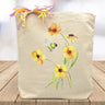 bubblebee with yellow flowers printed on canvas tote bag sitting on table with white blurred background