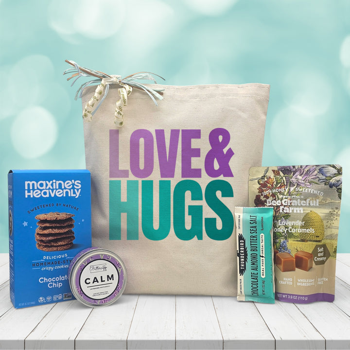Love and Hugs gift tote bag with chocolate chip cookies, lavender honey caramels, almond butter bar, and a calm candle