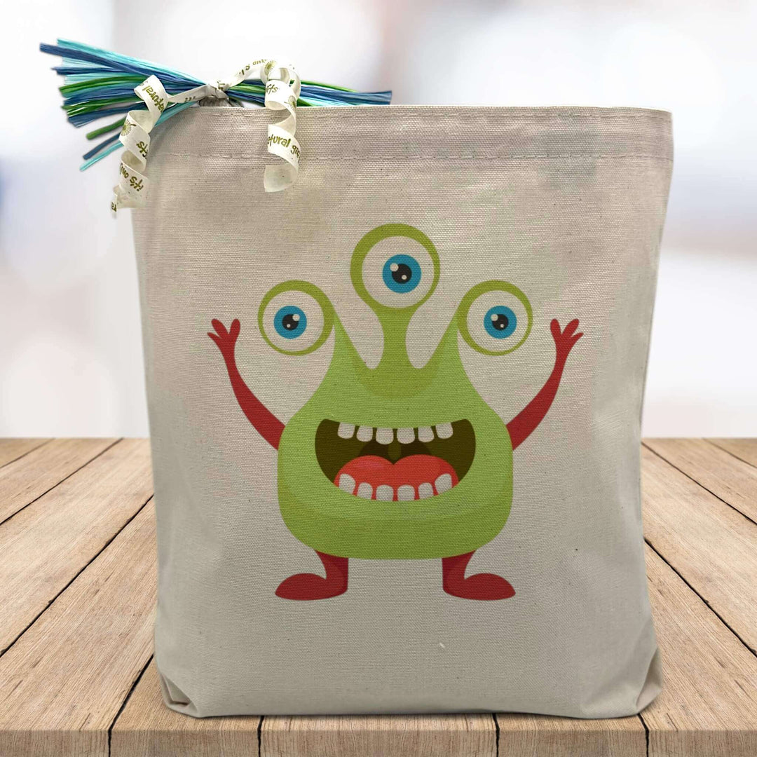 green monster printed on a canvas tote bag sitting on a table