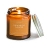 Pumpkin and spices soy candle in an amber glass jar