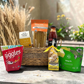 wicker basket with tea, pasta, pasta sauce, chewy candies, caramels, and tea