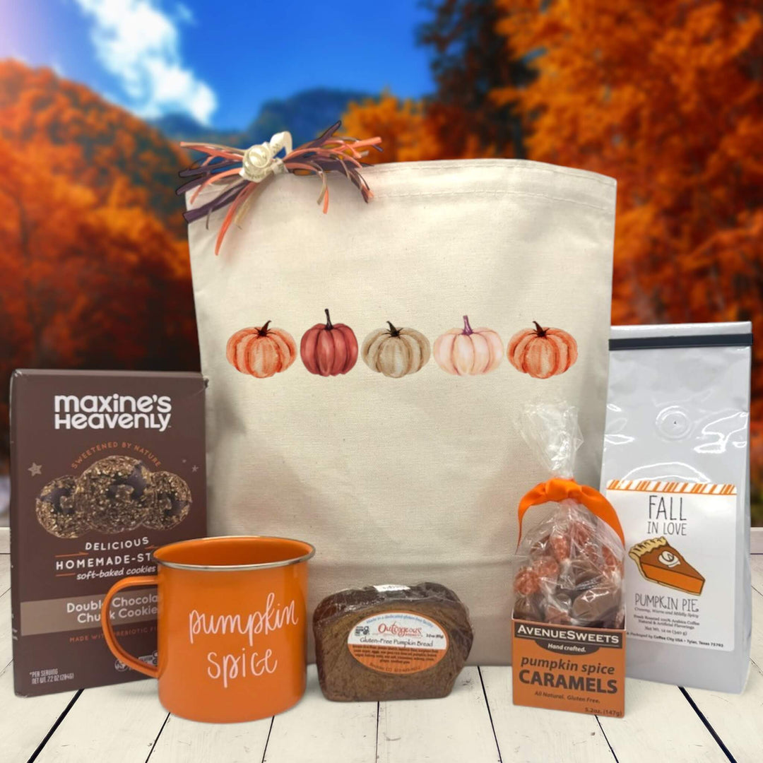 Gourmet Fall gift basket with cookies, a mug, bread, caramels, and pumpkin cocoa sitting on a table