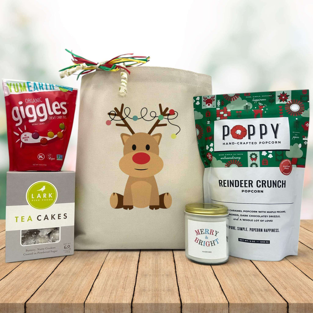 Gourmet holiday gift basket with fruit candies, tea cake cookies, large candles and popcorn