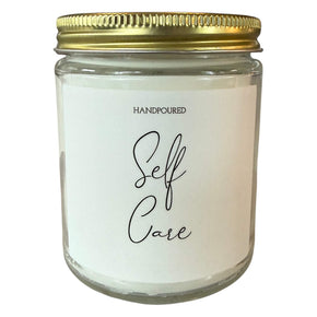 Self Care printed in cursive on candle