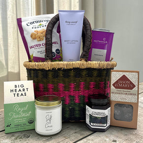 valentines basket with popcorn, lotion, cocoa, tea, a large candle, jam and caramels