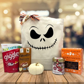 halloween gift basket with candies, chocolate, knit pumpkin, cherry buds and cookies