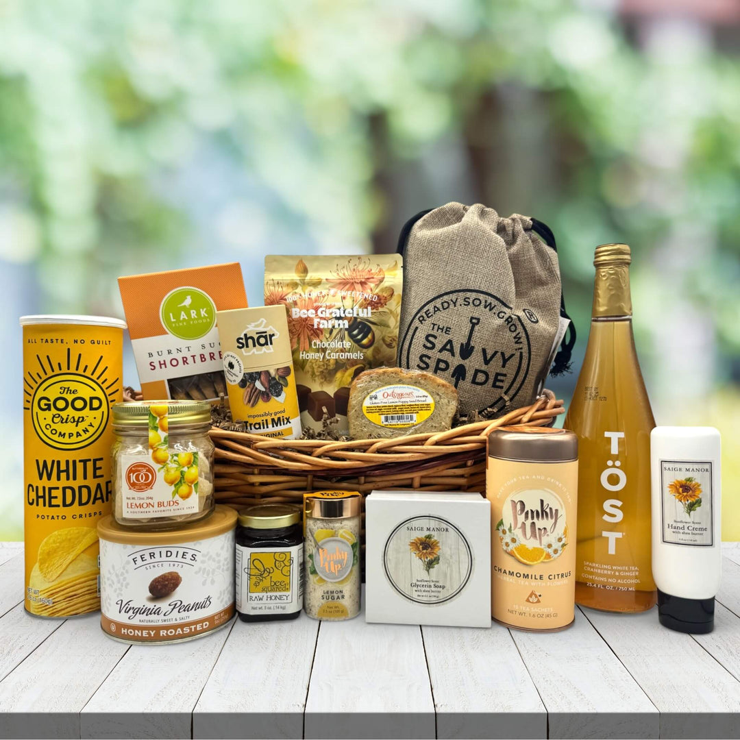 Medium Wicker basket filled to the top with all snack favorites and spa essentials sitting on a table 