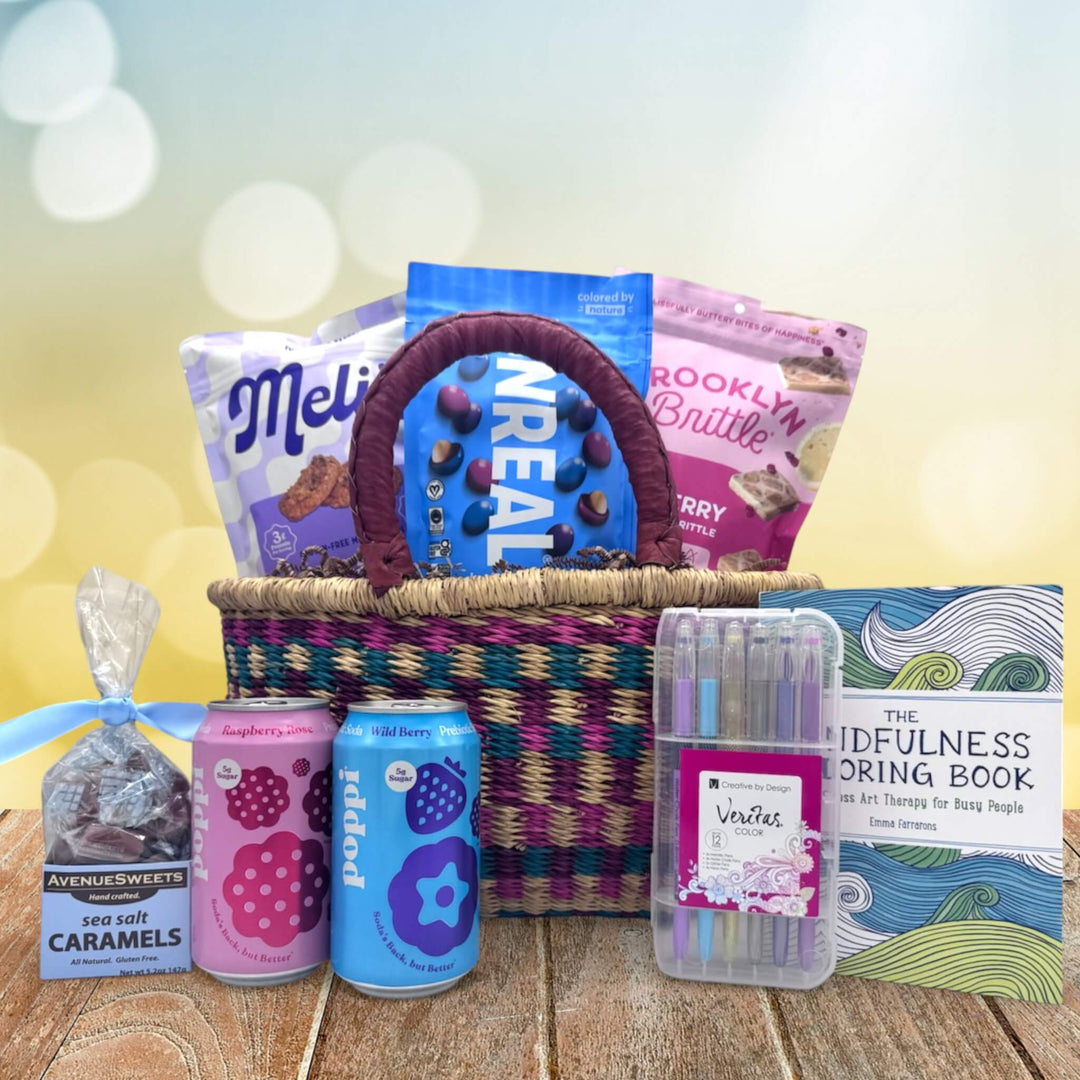 colorful medium african market basket filled with refreshing snacks and drinks siting on a table