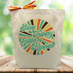 stay trippy little hippy with stripped circle printed on canvas tote bag sitting on table with green blurrred background