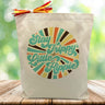 stay trippy little hippy with stripped circle printed on canvas tote bag sitting on table with green blurrred background