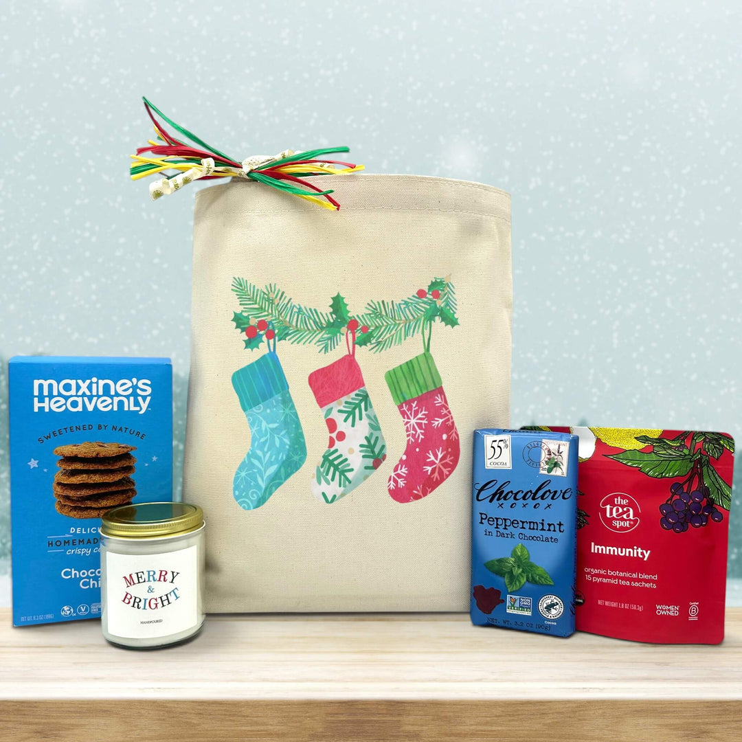 Gourmet holiday gift basket with cookies, a merry and bright candle, peppermint chocolate, and immunity tea