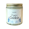 sugar cookie script with trees and dots printed on the front of a candle