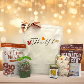 Thankful script basket with pretzels, cramels, honey, pumpkin spice chai, and pecans sitting on a table