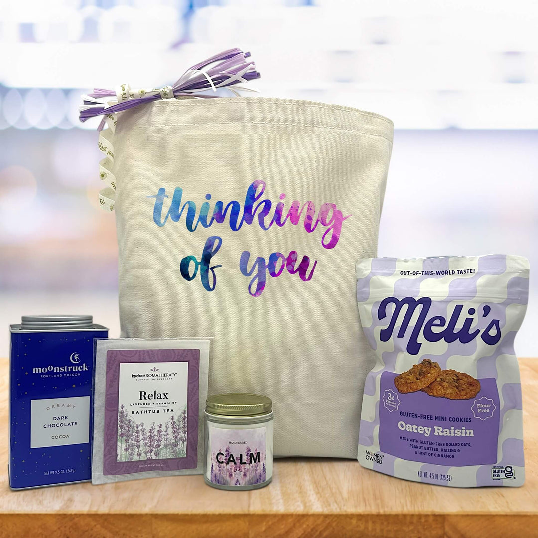 blue pink and purple thinking of you themed gift with cocoa, bathtub tea, candle and cookies