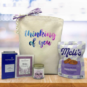 blue pink and purple thinking of you themed gift with cocoa, bathtub tea, candle and cookies