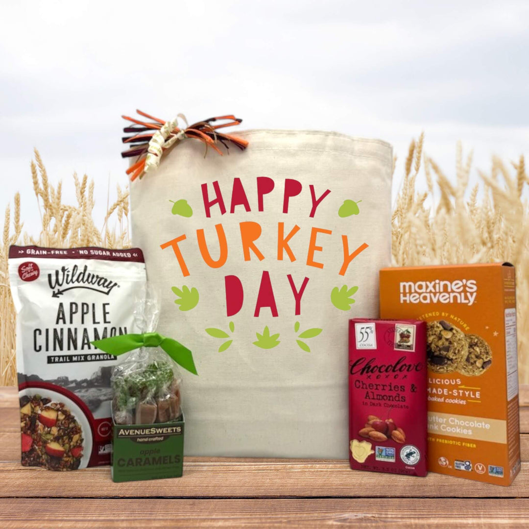 Gourmet thanksgiving gift with granola, caramels, chocolate, and cookies sitting on a table with a fall background