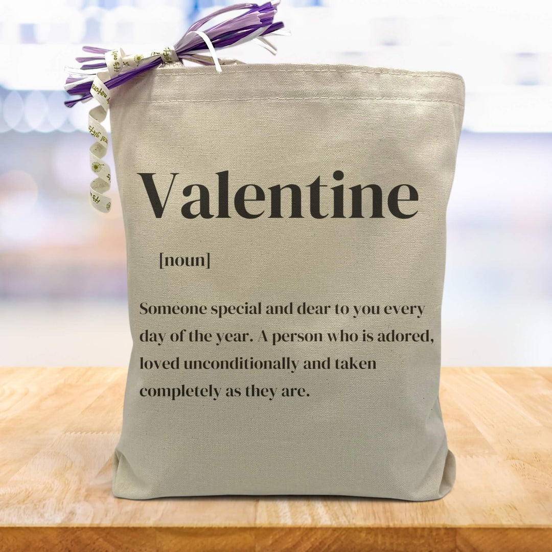 valentine definition printed on a canvas tote bag sitting on a table
