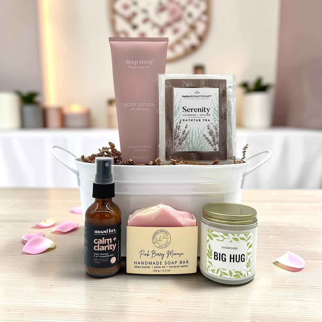 white small tin tub with lotion, bathtub tea, calming spritz, soap, and a candle