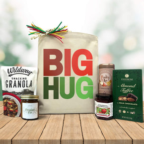 gourmet holiday gift basket with granola, a candle, jam, tea and almond toffee