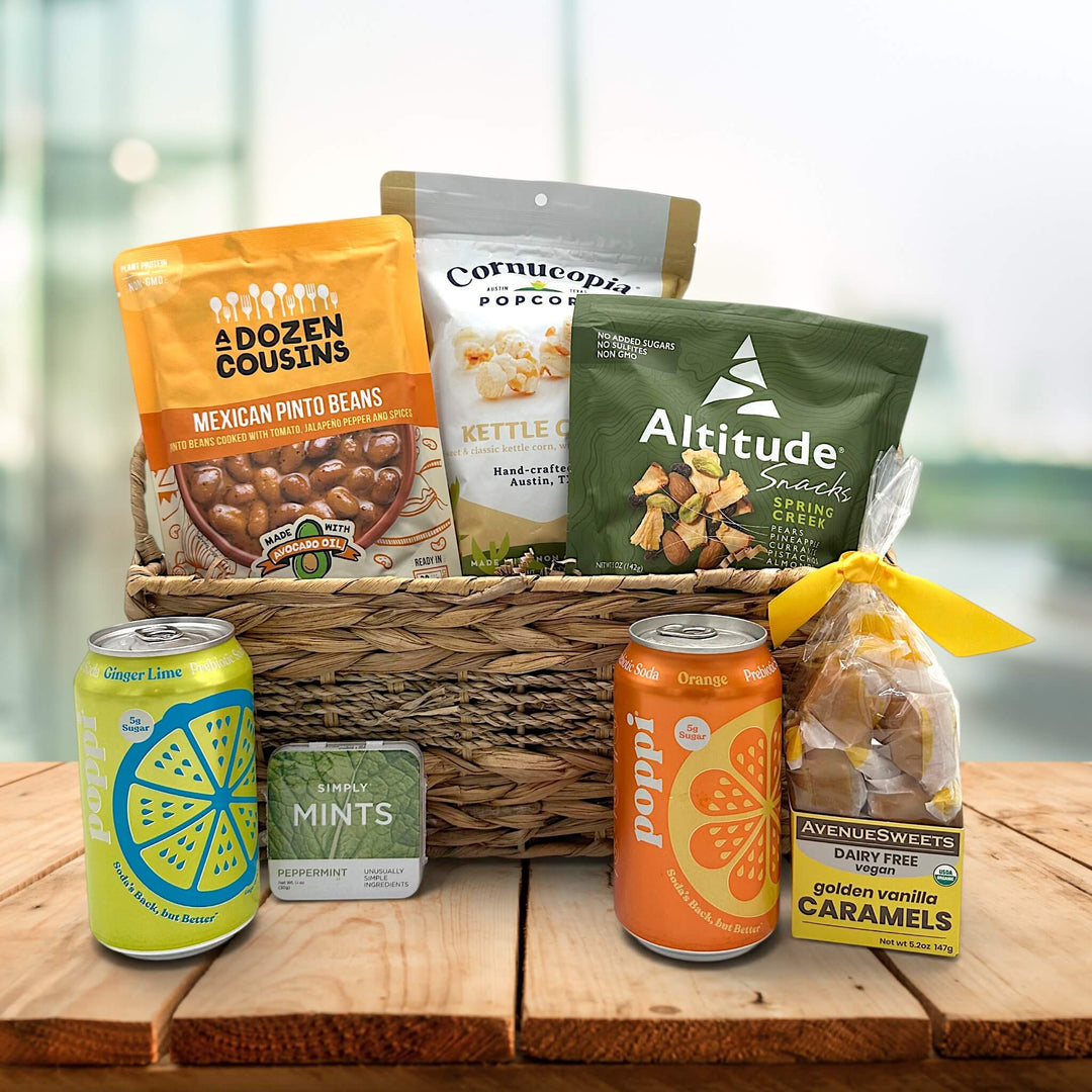 wicker basket with pocorn, trail mix, pinto beans, poppi drinks, mints and caramels