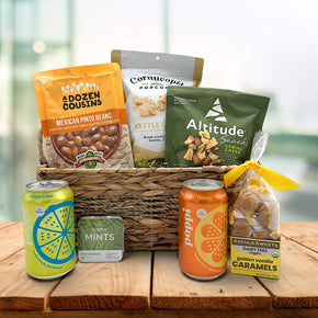 wicker basket with pocorn, trail mix, pinto beans, poppi drinks, mints and caramels