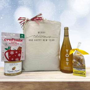 gourmet christmas and new years gift basket with a seasonal drink mix, peanuts, sparklin juice, and caramels