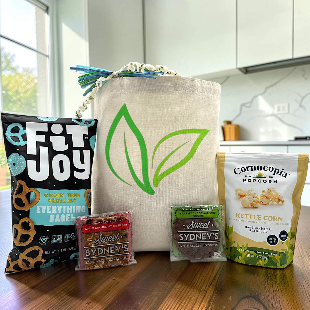 vegan gift basket with everything bagel pretzels, apple cranberry bar, a sea salt chocolate bar, and popcorn
