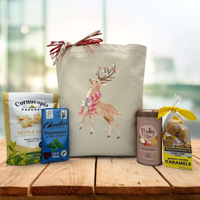 holiday vegan gift basket with popcorn, chocolate bar, tea, and caramels