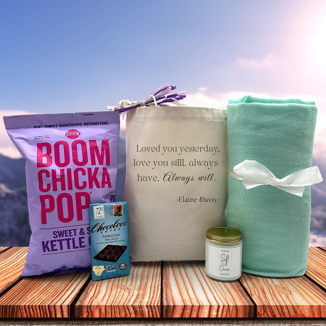 Heartfelt gift with kettle corn popcorn, a chocolate bar, a large candle and a large blanket