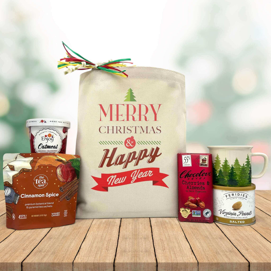 gourmet holiday and new year basket with oatmeal, tea, chocolate bar, peanuts, and a mug