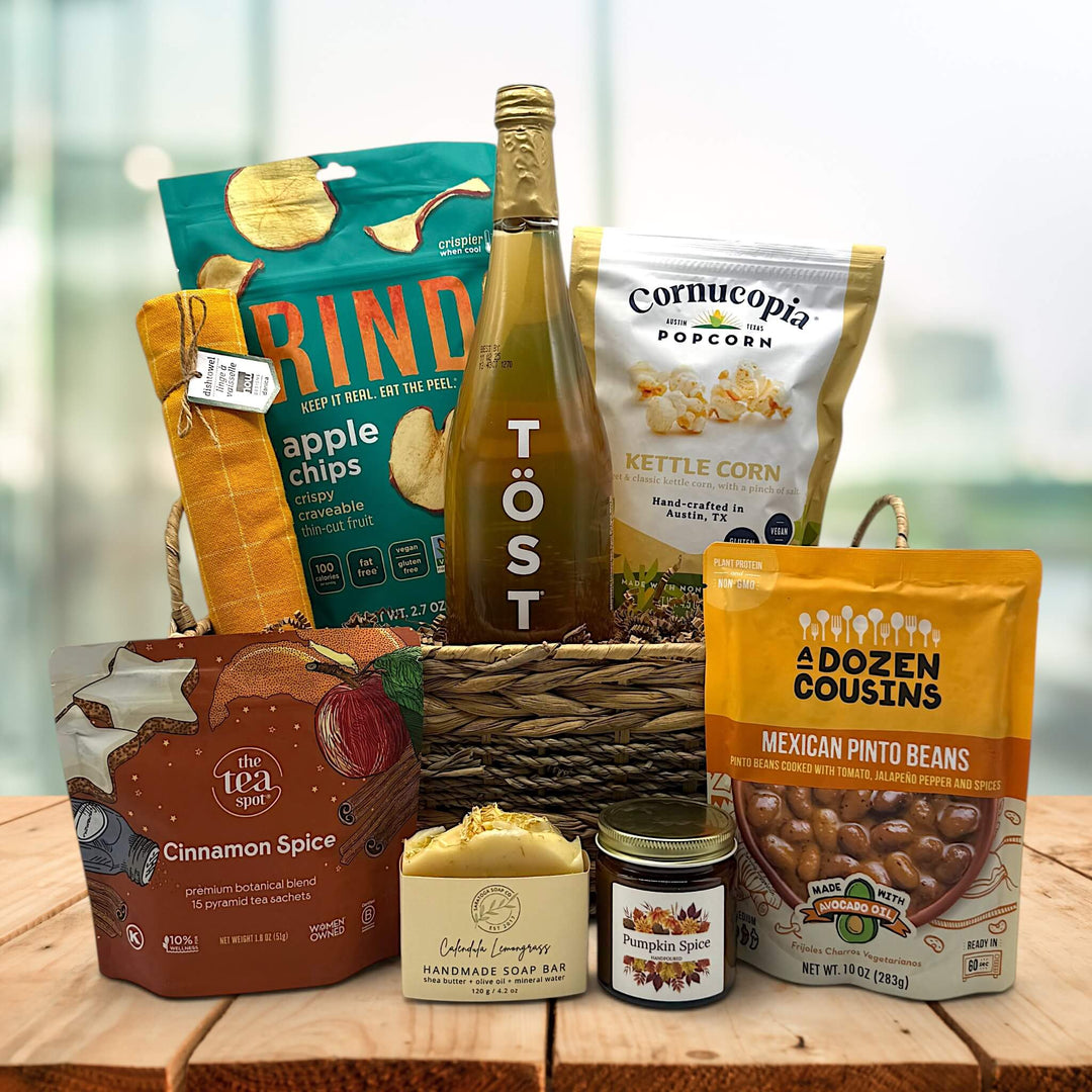 Gourmet wicker basket with apple chips, sparking juice, popcorn, tea, soap, a candle, mexican pinto beans and more