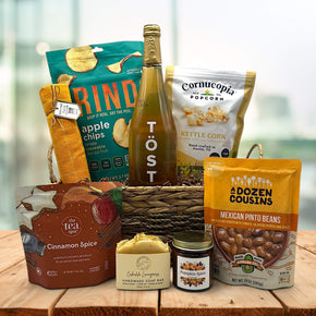 Gourmet wicker basket with apple chips, sparking juice, popcorn, tea, soap, a candle, mexican pinto beans and more
