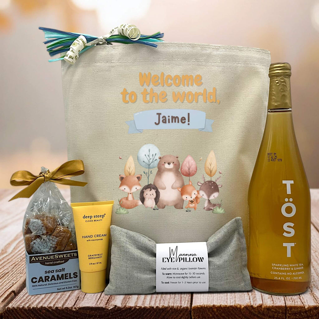 welcome to the world with custom name with caramels, hand cream, eye pillow and tost on table
