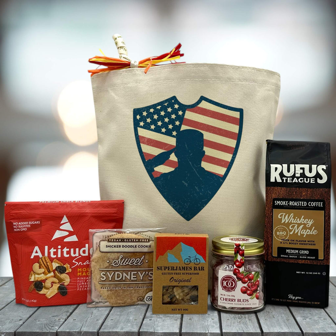 tote bag sitting on table with image of salute with trail mix, cookie, superjames bar, cherry buds, and coffee