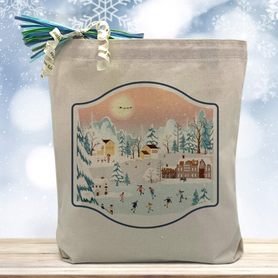 winter wonderland scene printed on a canvas tote bag sitting on a table with a snowflake background