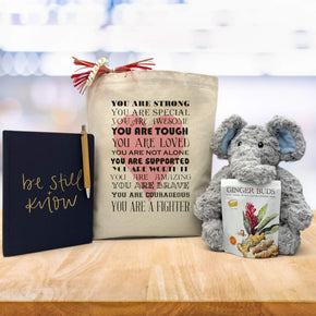 you are strong design on canvas tote bag with a journal, ginger buds and an elephant stuffed animal